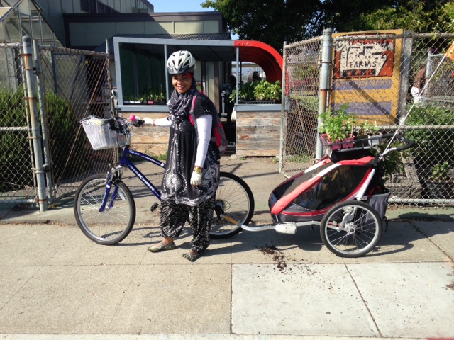 Backyard Gardener Aishah with plants in bike trailer Backyard Gardener Aishah with plants in bike trailer